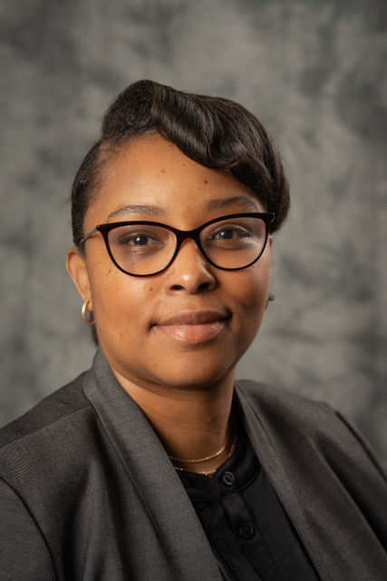 Woman in proffesional wear and glasses smiling