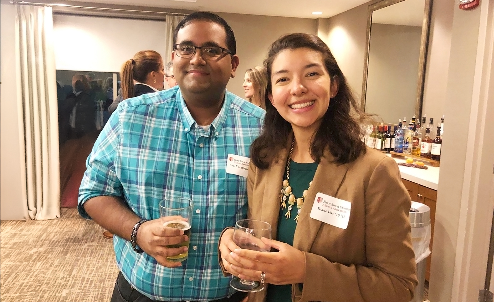 Two alumni posing at an event