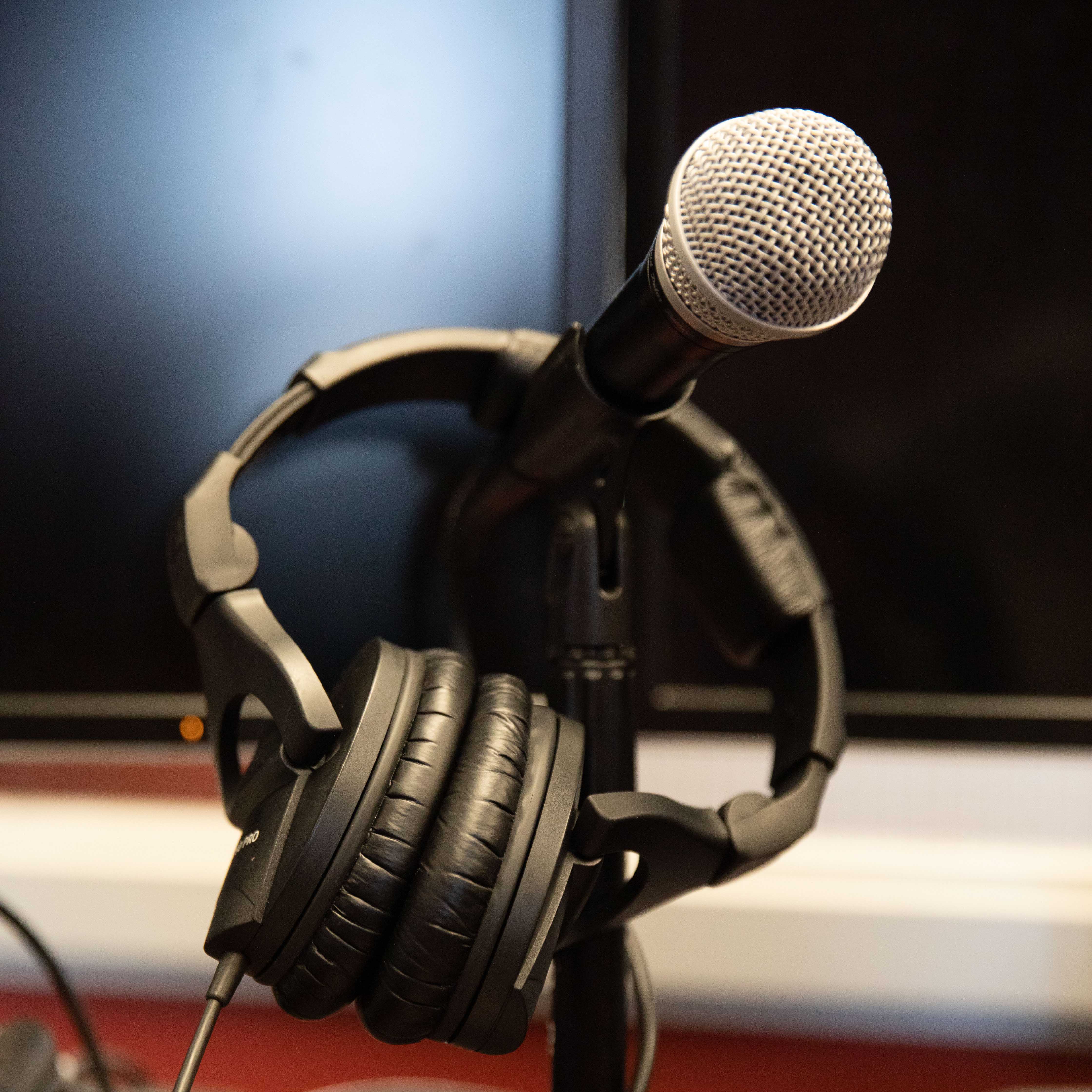 microphone with headphones wrapped around the stand