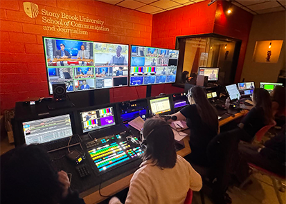 Picture of students at the production console in the School of Communications and Journalism studio